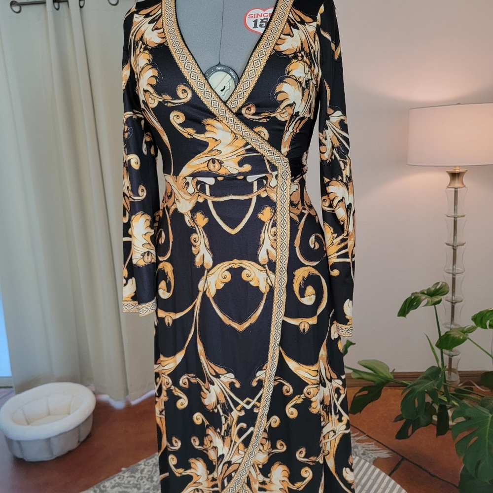 Gorgeous wrap dress. Black, gold and white. Will fit sizes 6-12.